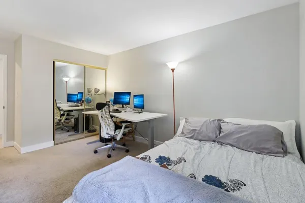 a bedroom with a bed a table and chairs