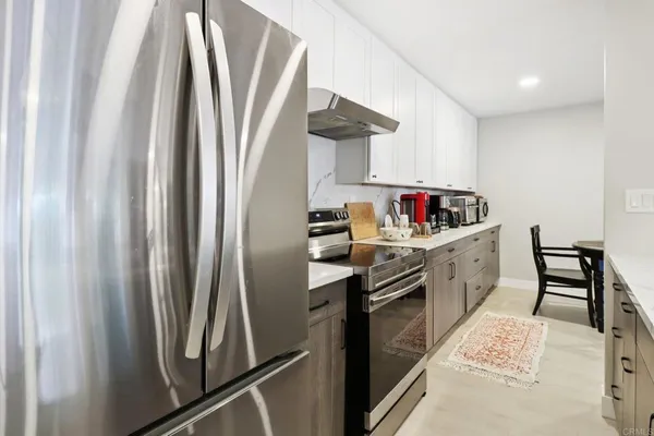 a kitchen with stainless steel appliances a refrigerator and a sink
