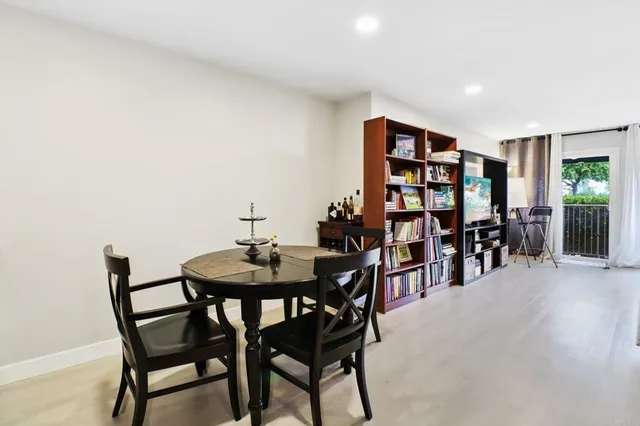 a dining room with furniture and wooden floor