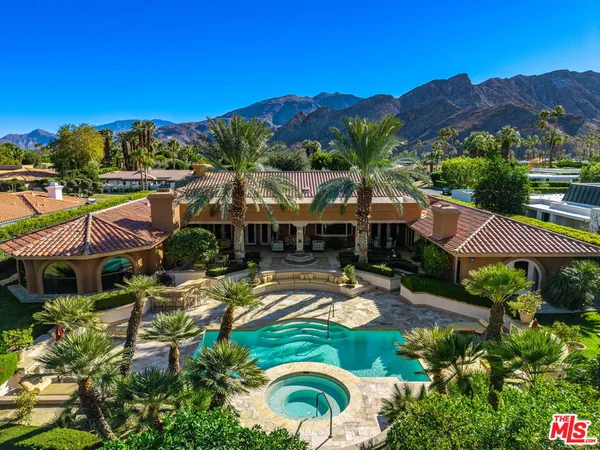 a view of a house with a garden and a swimming pool