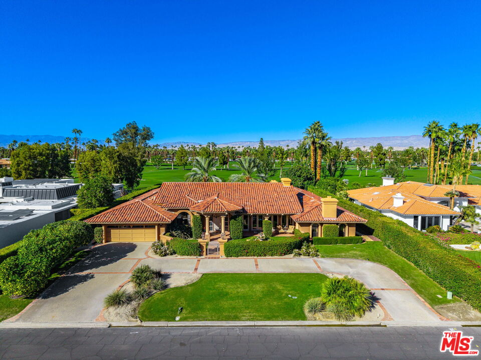 71150 North Thunderbird Terrace Rancho Mirage, CA 92270 - Photo 2 of 75 a view of lawn with swimming pool and outdoor seating