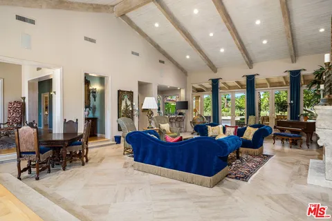 a kitchen with granite countertop a sink a stove and refrigerator
