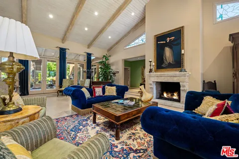 a view of a room with a large window and wooden floor