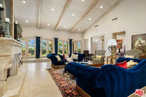 a view of a dining room with furniture wooden floor and chandelier