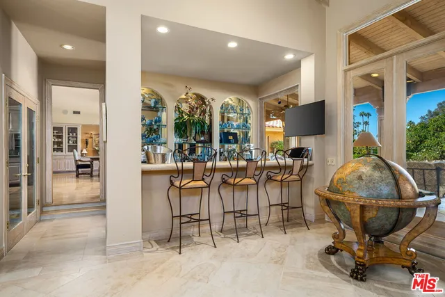 a kitchen with granite countertop a sink a stove and refrigerator
