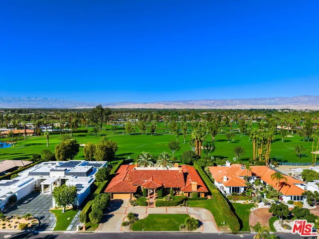 an aerial view of a house with a yard and potted plants
