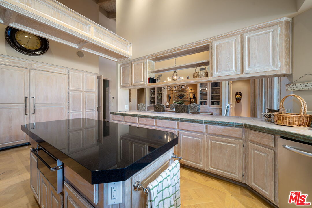 71150 North Thunderbird Terrace Rancho Mirage, CA 92270 - Photo 34 of 75 a kitchen with stainless steel appliances granite countertop a sink a oven and cabinets