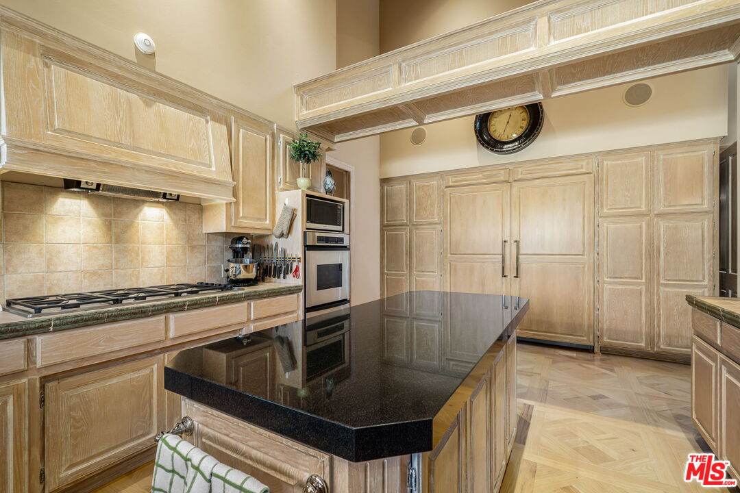 71150 North Thunderbird Terrace Rancho Mirage, CA 92270 - Photo 35 of 75 a kitchen with granite countertop a sink a stove and refrigerator