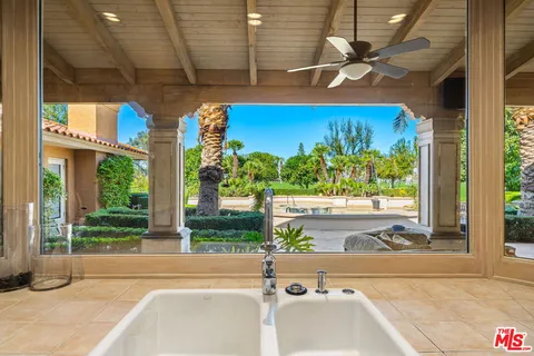 a bedroom with a bed mirror and window