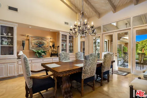 a bathroom with a granite countertop toilet a sink and a mirror