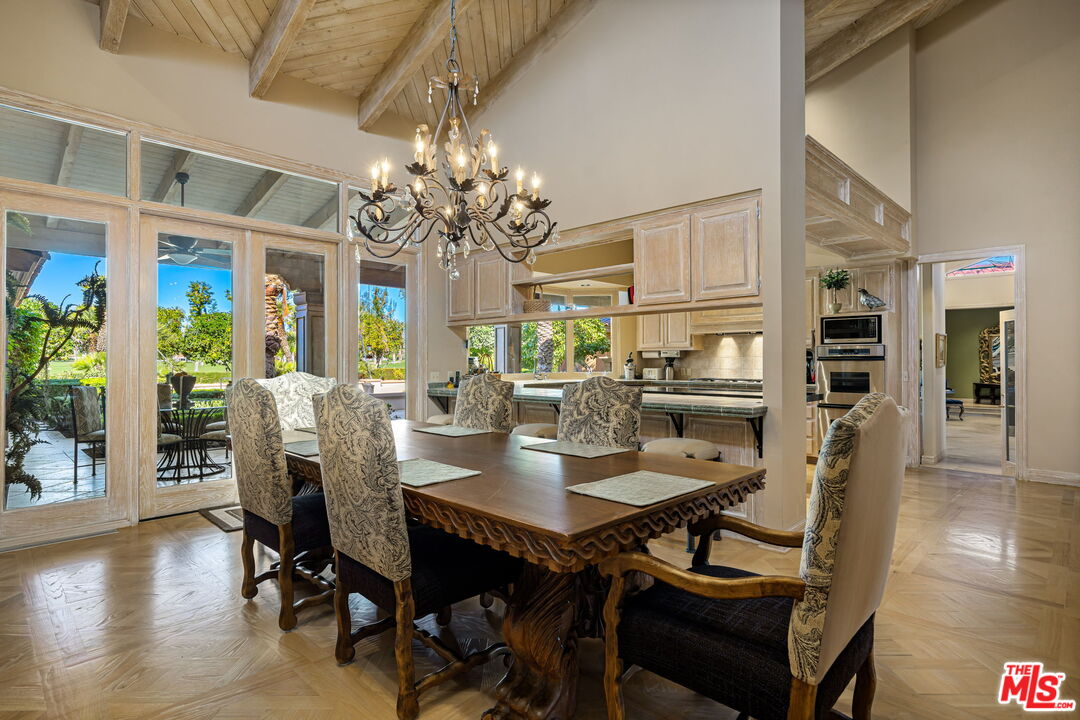 71150 North Thunderbird Terrace Rancho Mirage, CA 92270 - Photo 38 of 75 a view of a dining room with furniture wooden floor and chandelier