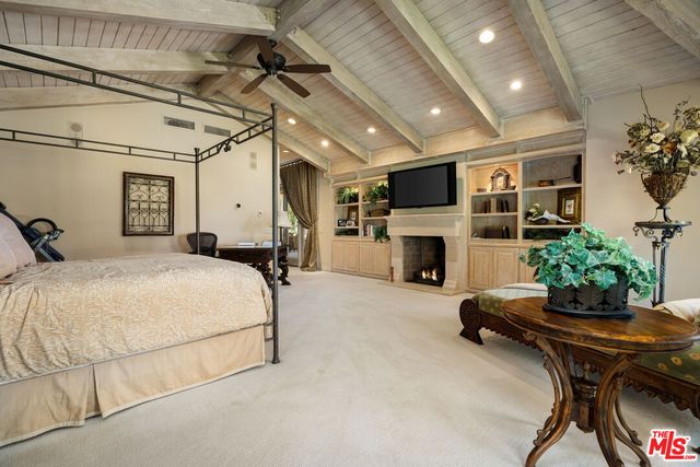 a backyard of a house with fire pit and outdoor seating