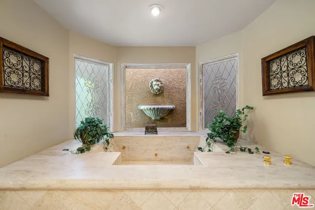a bathroom with a granite countertop toilet a sink and a mirror