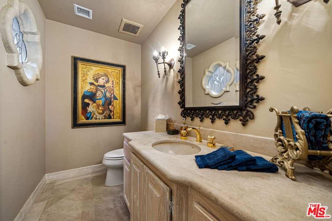 71150 North Thunderbird Terrace Rancho Mirage, CA 92270 - Photo 50 of 75 a bathroom with a sink a vanity and a mirror