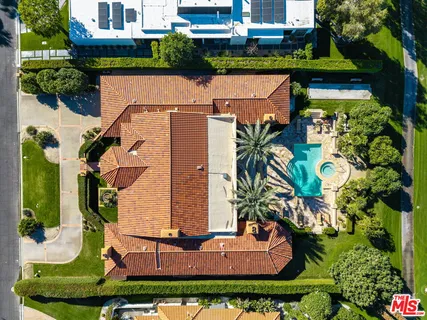 an aerial view of a house with a swimming pool