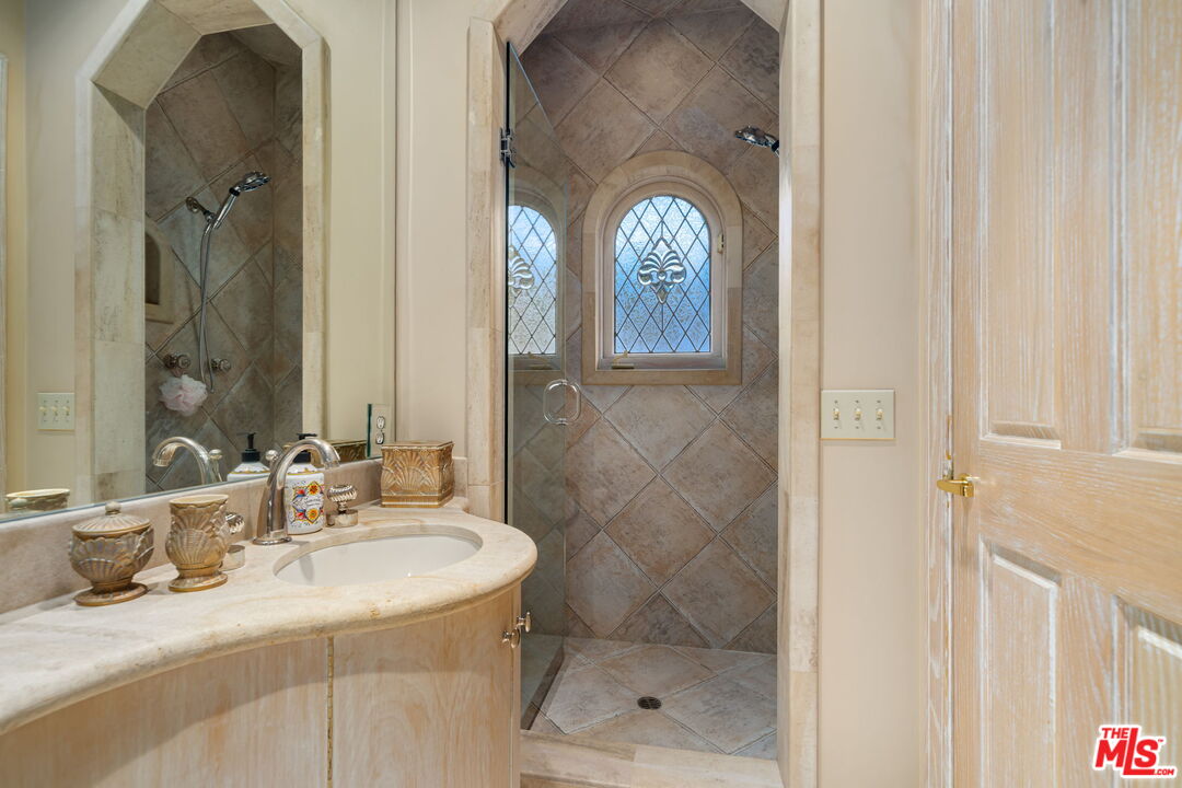 71150 North Thunderbird Terrace Rancho Mirage, CA 92270 - Photo 52 of 75 a bathroom with a sink a toilet and shower