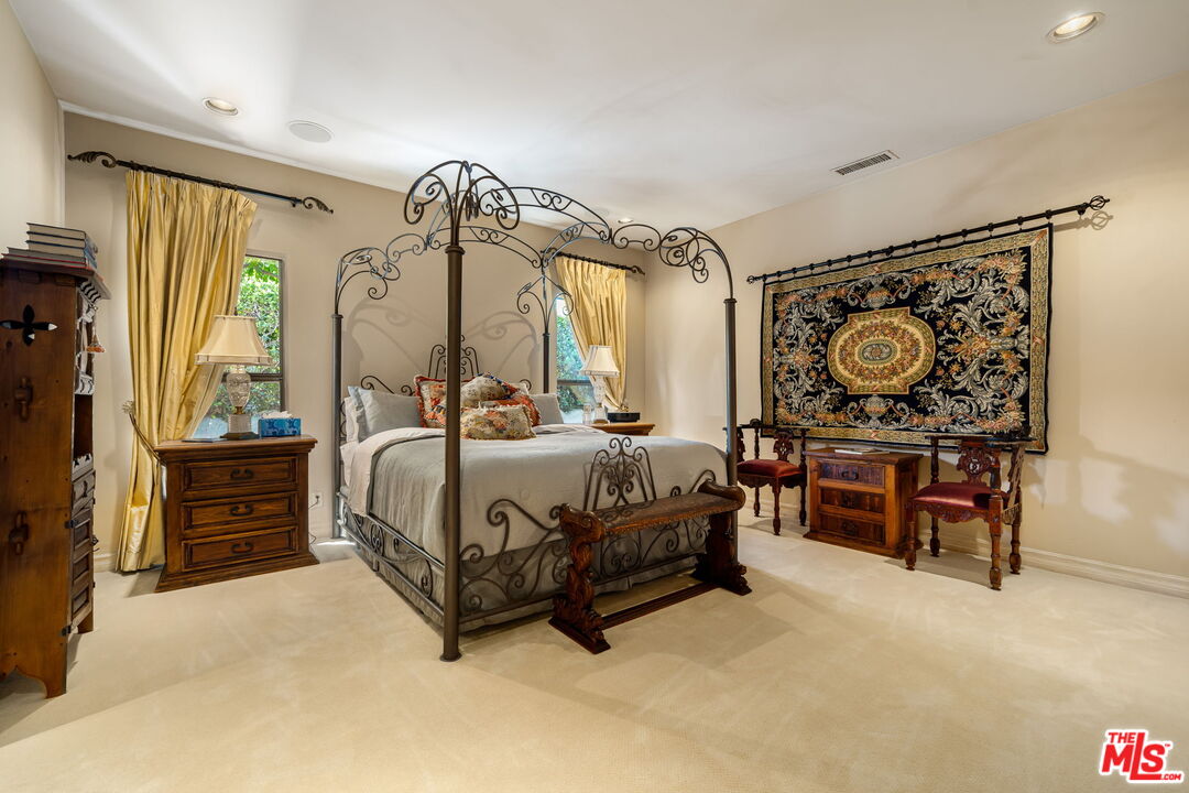 71150 North Thunderbird Terrace Rancho Mirage, CA 92270 - Photo 53 of 75 a bedroom with a bed mirror and window