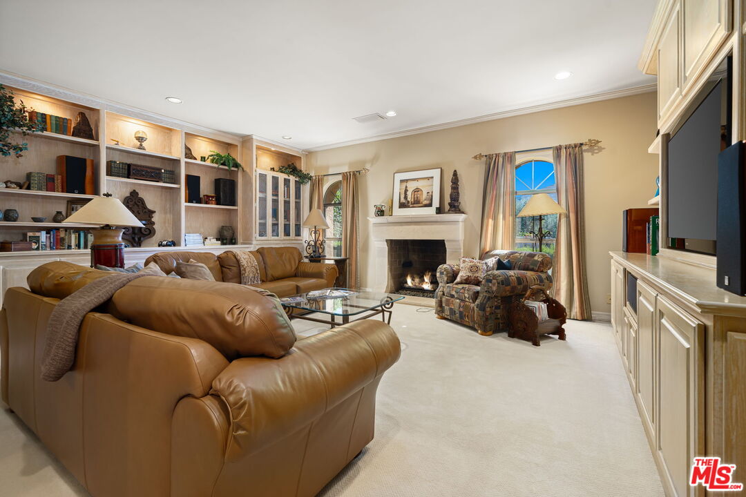 71150 North Thunderbird Terrace Rancho Mirage, CA 92270 - Photo 55 of 75 a living room with furniture flat screen tv and a fireplace