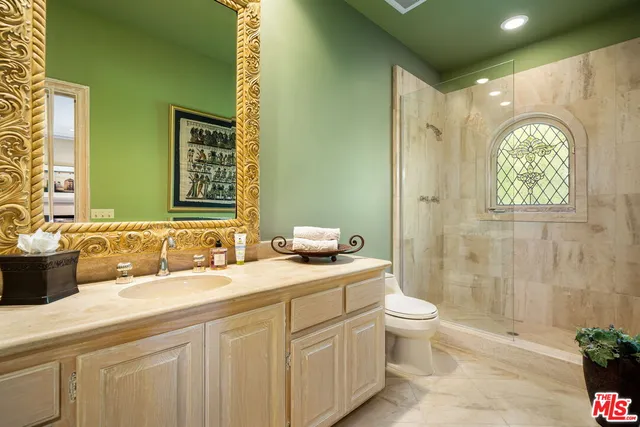 a view of a backyard with couches table and chairs and potted plants