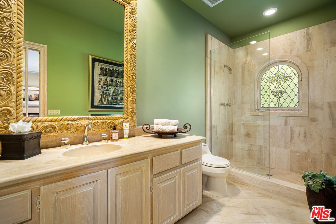 71150 North Thunderbird Terrace Rancho Mirage, CA 92270 - Photo 57 of 75 a bathroom with a sink a toilet and a mirror