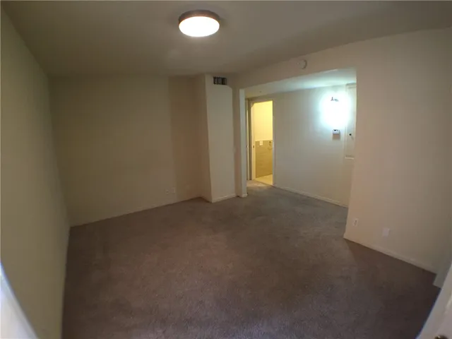a view of a livingroom with furniture wooden floor and a floor to ceiling window