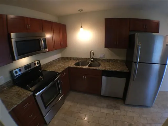 a kitchen with a refrigerator and a sink