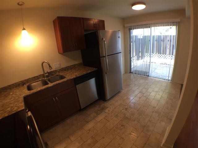 2800 Cole Street, Unit 103C Austin, TX 78705 - Photo 5 of 16 a kitchen with a refrigerator and a sink