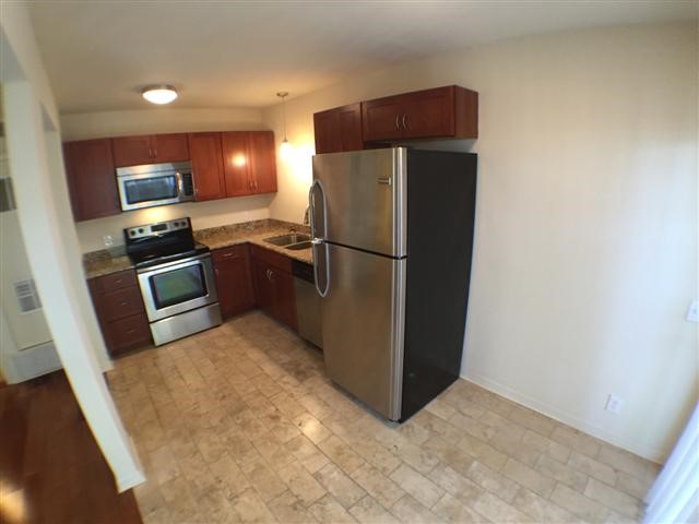 2800 Cole Street, Unit 103C Austin, TX 78705 - Photo 6 of 16 a kitchen with a refrigerator and a stove