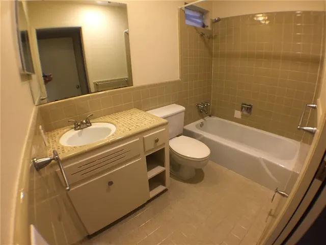 an empty room with closet and windows