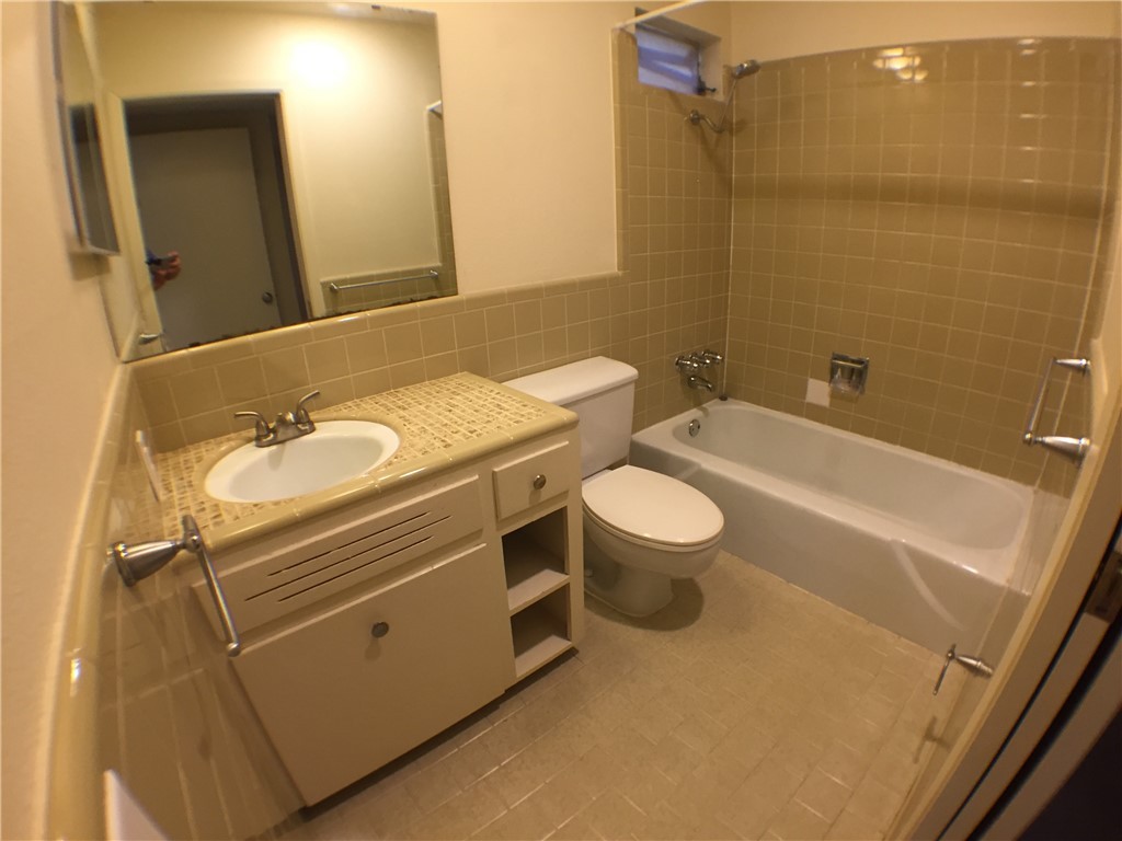 2800 Cole Street, Unit 103C Austin, TX 78705 - Photo 7 of 16 a bathroom with a granite countertop sink toilet and shower