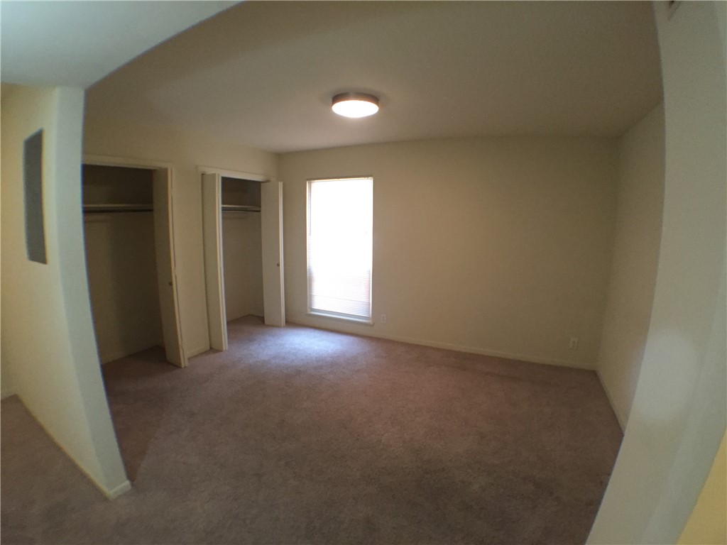 2800 Cole Street, Unit 103C Austin, TX 78705 - Photo 8 of 16 an empty room with closet and windows