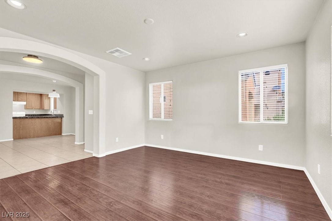 6909 Graceful Cloud Avenue Las Vegas, NV 89122 - Photo 13 of 33 Unfurnished room featuring arched walkways, recessed lighting, and light wood-style floors