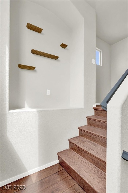 6909 Graceful Cloud Avenue Las Vegas, NV 89122 - Photo 15 of 33 Staircase featuring baseboards and wood finished floors