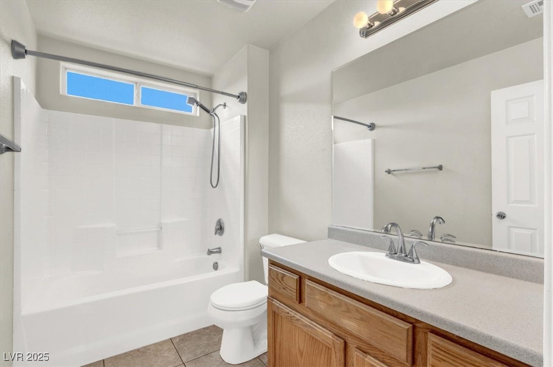 6909 Graceful Cloud Avenue Las Vegas, NV 89122 - Photo 17 of 33 Bathroom featuring vanity, shower / tub combination, and light tile patterned floors