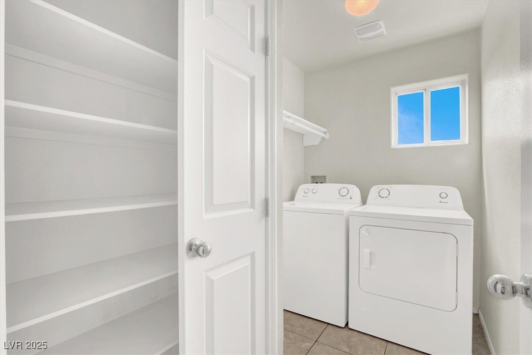 6909 Graceful Cloud Avenue Las Vegas, NV 89122 - Photo 18 of 33 Laundry room with tile patterned floors and washer and clothes dryer