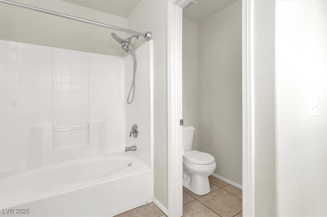 6909 Graceful Cloud Avenue Las Vegas, NV 89122 - Photo 26 of 33 Full bathroom featuring light tile patterned flooring and tub / shower combination