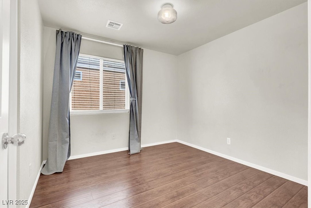 6909 Graceful Cloud Avenue Las Vegas, NV 89122 - Photo 27 of 33 Spare room with dark wood-style floors