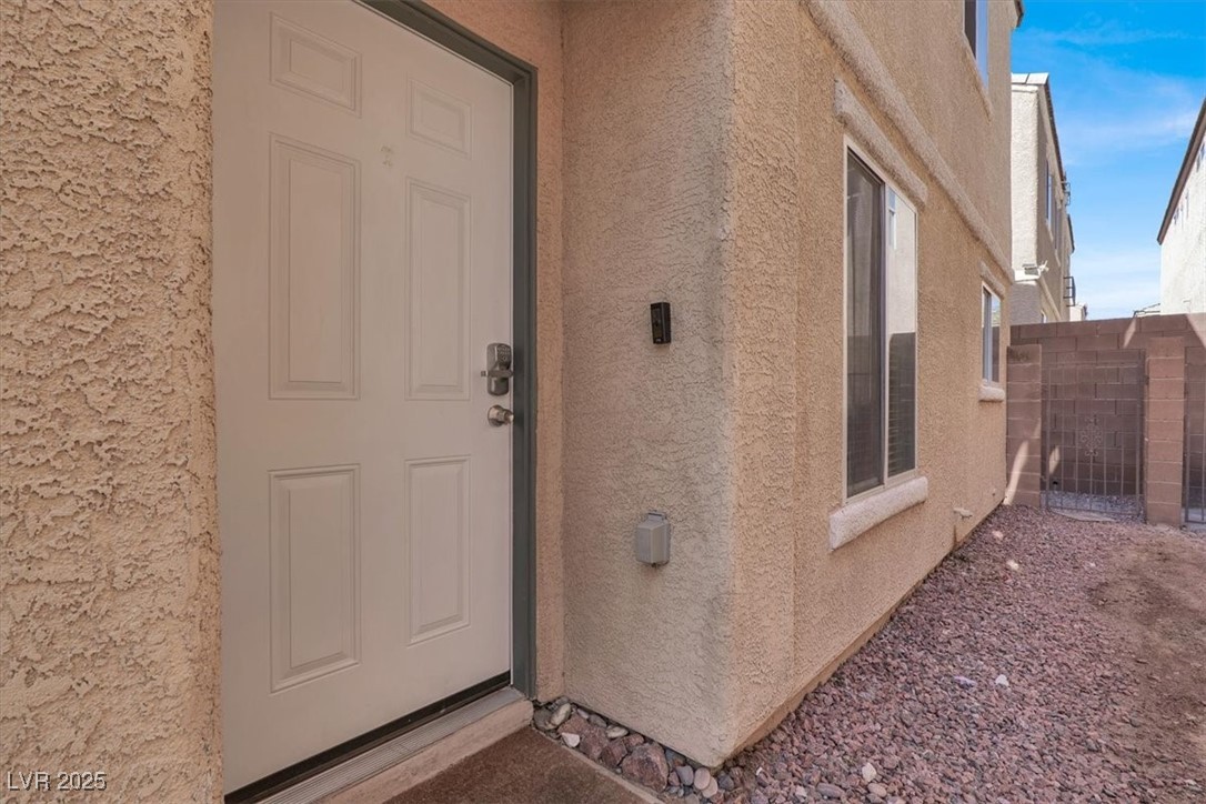 6909 Graceful Cloud Avenue Las Vegas, NV 89122 - Photo 3 of 33 View of exterior entry with stucco siding