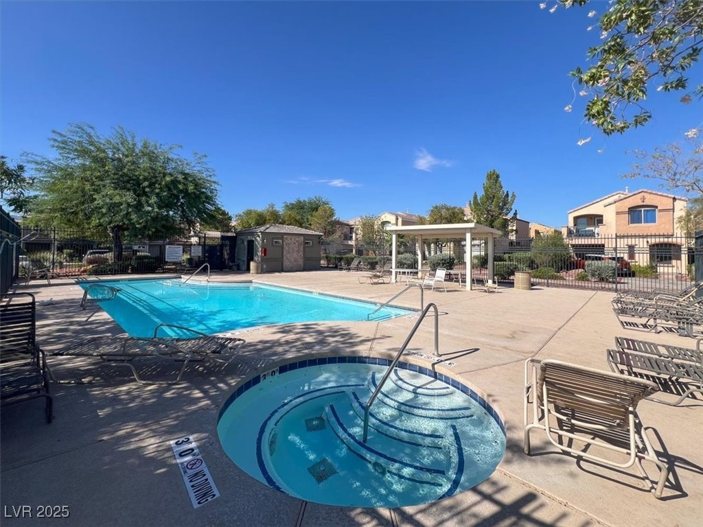 6909 Graceful Cloud Avenue Las Vegas, NV 89122 - Photo 32 of 33 Community pool with a hot tub and a patio