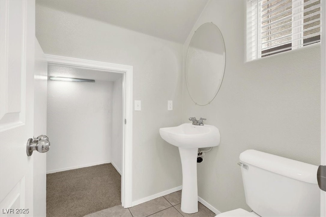 6909 Graceful Cloud Avenue Las Vegas, NV 89122 - Photo 9 of 33 Half bath featuring carpet floors and tile patterned floors