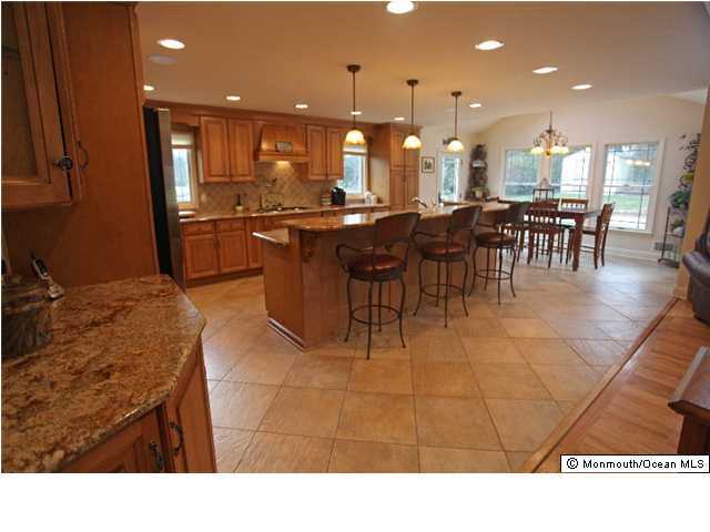 28 Ravine Road Middletown, NJ 07701 - Photo 3 of 3 a kitchen with a dining table chairs and a kitchen view
