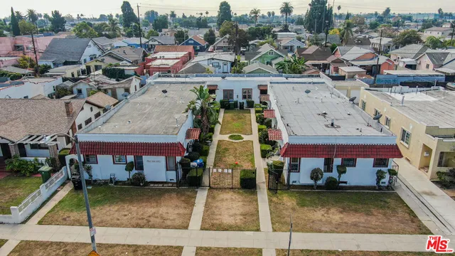 an aerial view of a tennis ground with large trees