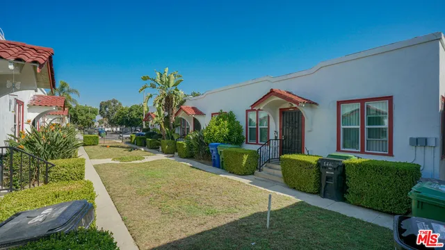 a view of an house with backyard space and porch