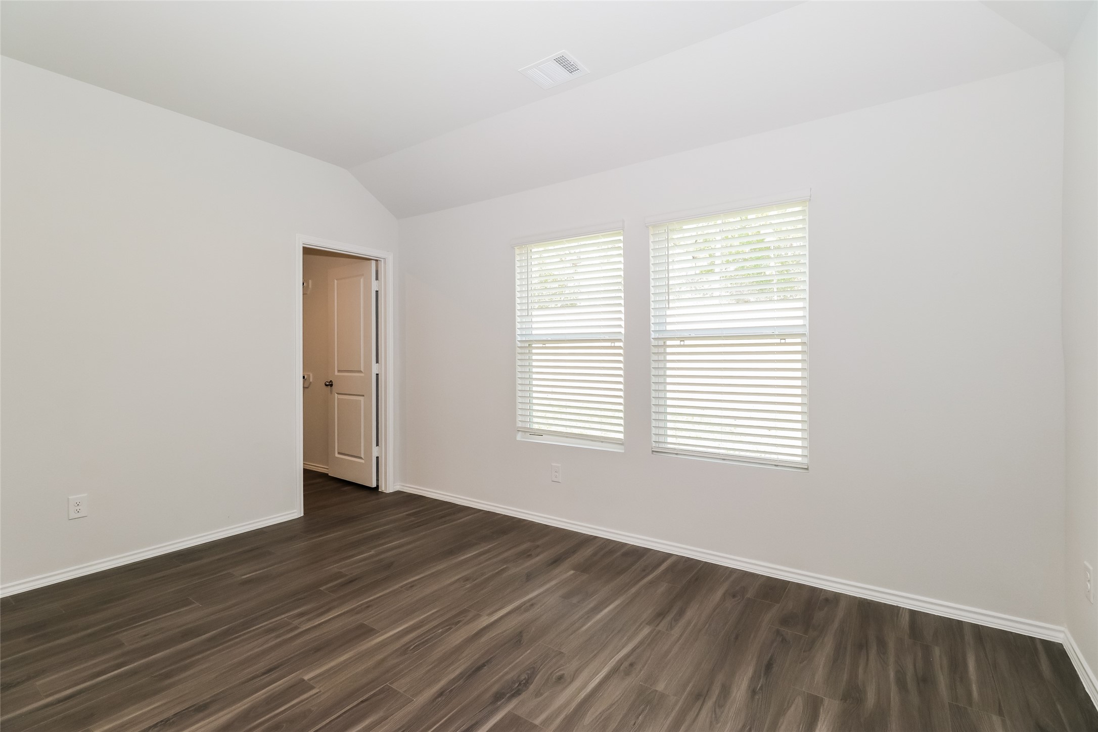 2257 Onyx Lane Conroe, TX 77301 - Photo 5 of 19 an empty room with wooden floor and windows