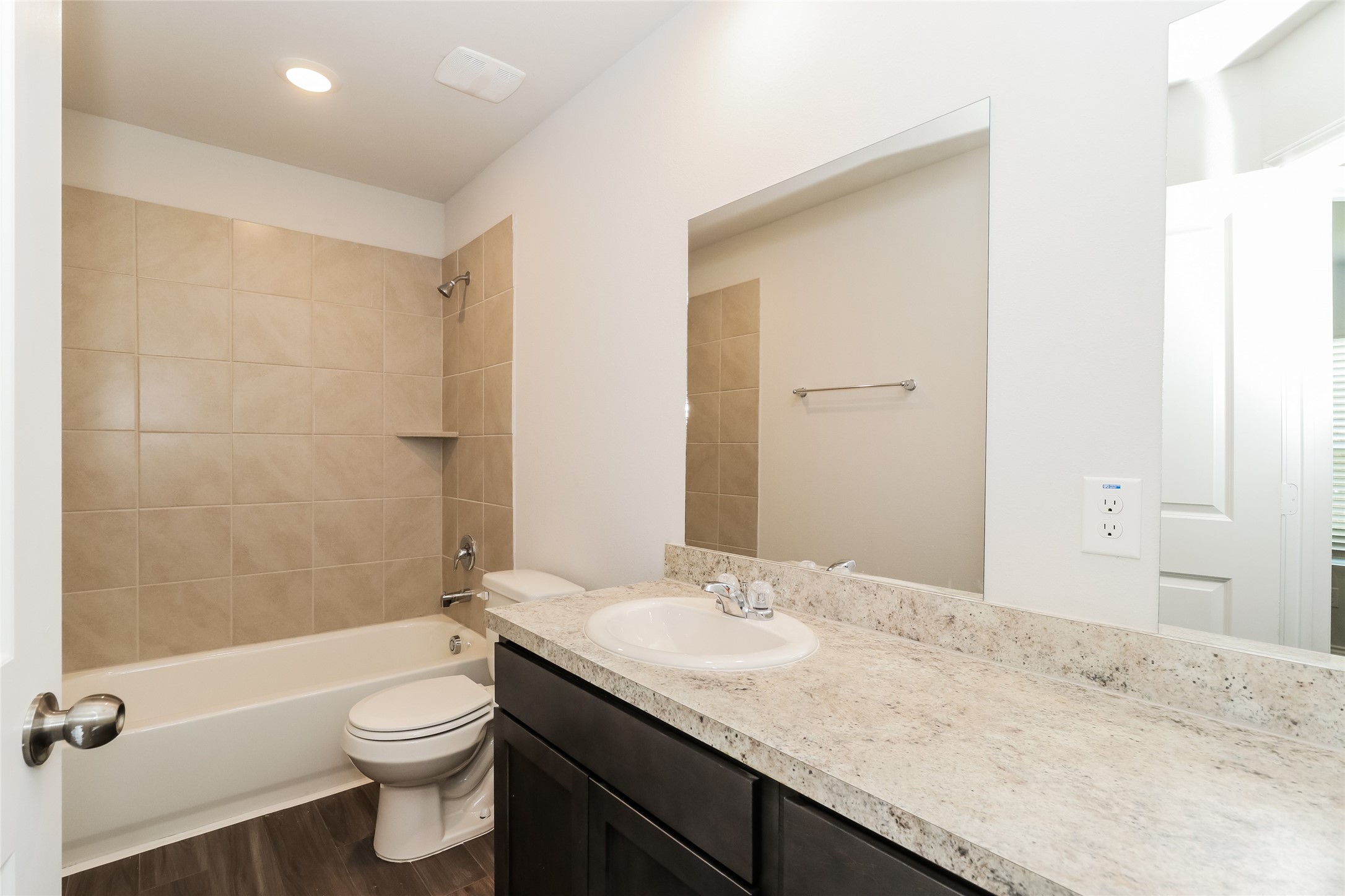 2257 Onyx Lane Conroe, TX 77301 - Photo 7 of 19 a bathroom with a granite countertop sink a toilet and shower