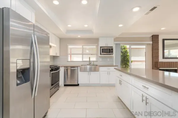 a large kitchen with stainless steel appliances lots of counter top space