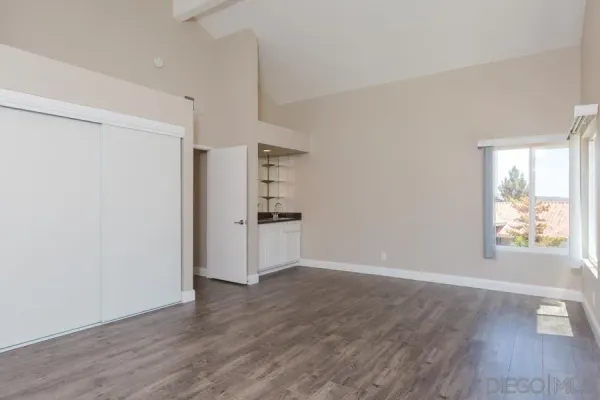 a view of wooden floor and windows in a room