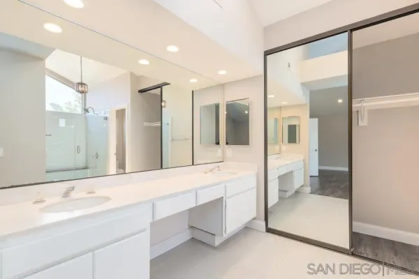 a bathroom with a double vanity sink and mirror