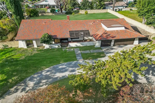 an aerial view of a house with yard swimming pool and outdoor seating
