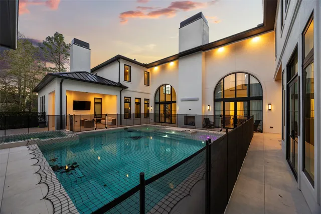 a view of swimming pool with a lounge chairs
